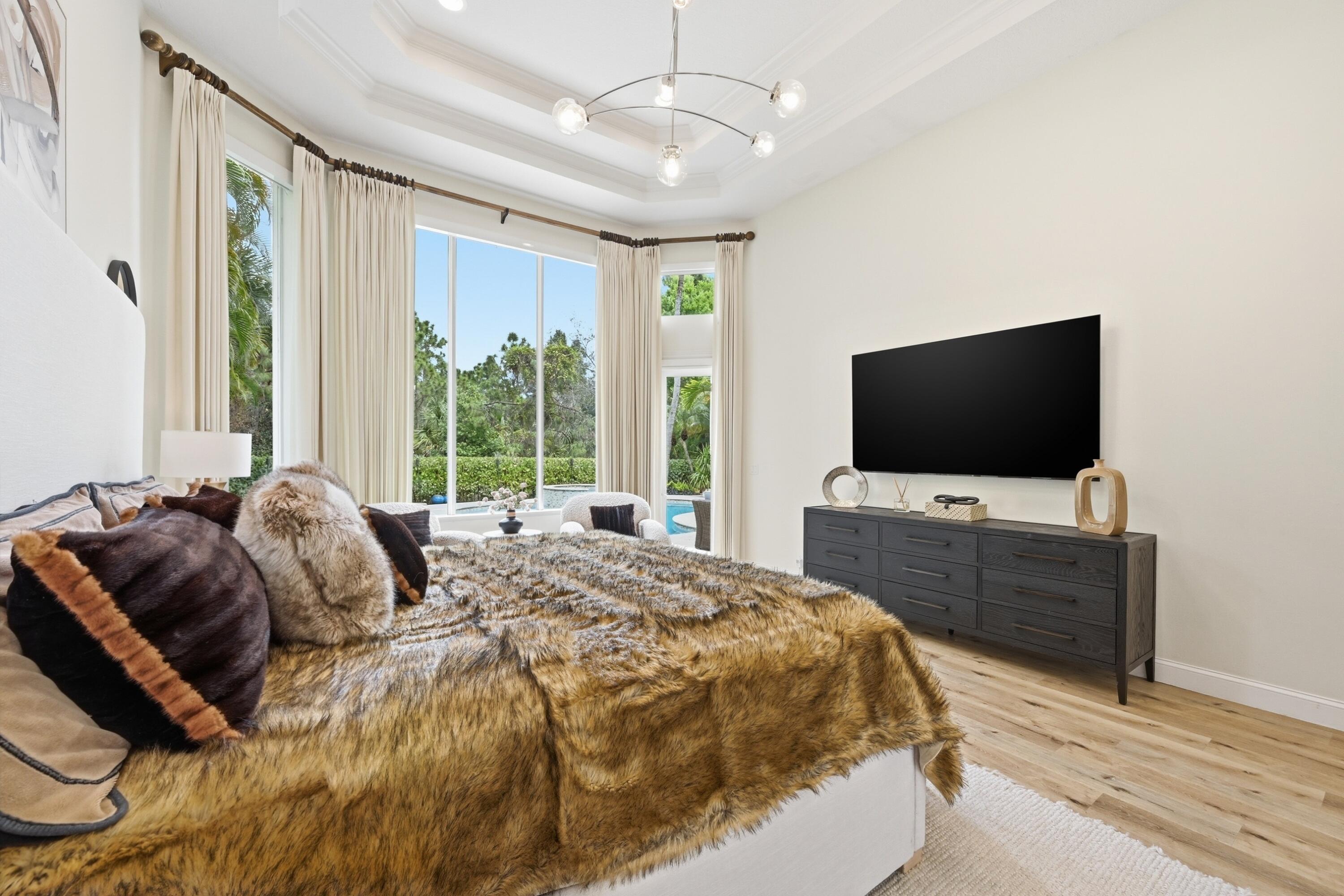 2399 Northwest 49th Lane Boca Raton, FL 33431 - Photo 28 of 75 a bedroom with a bed and a flat screen tv