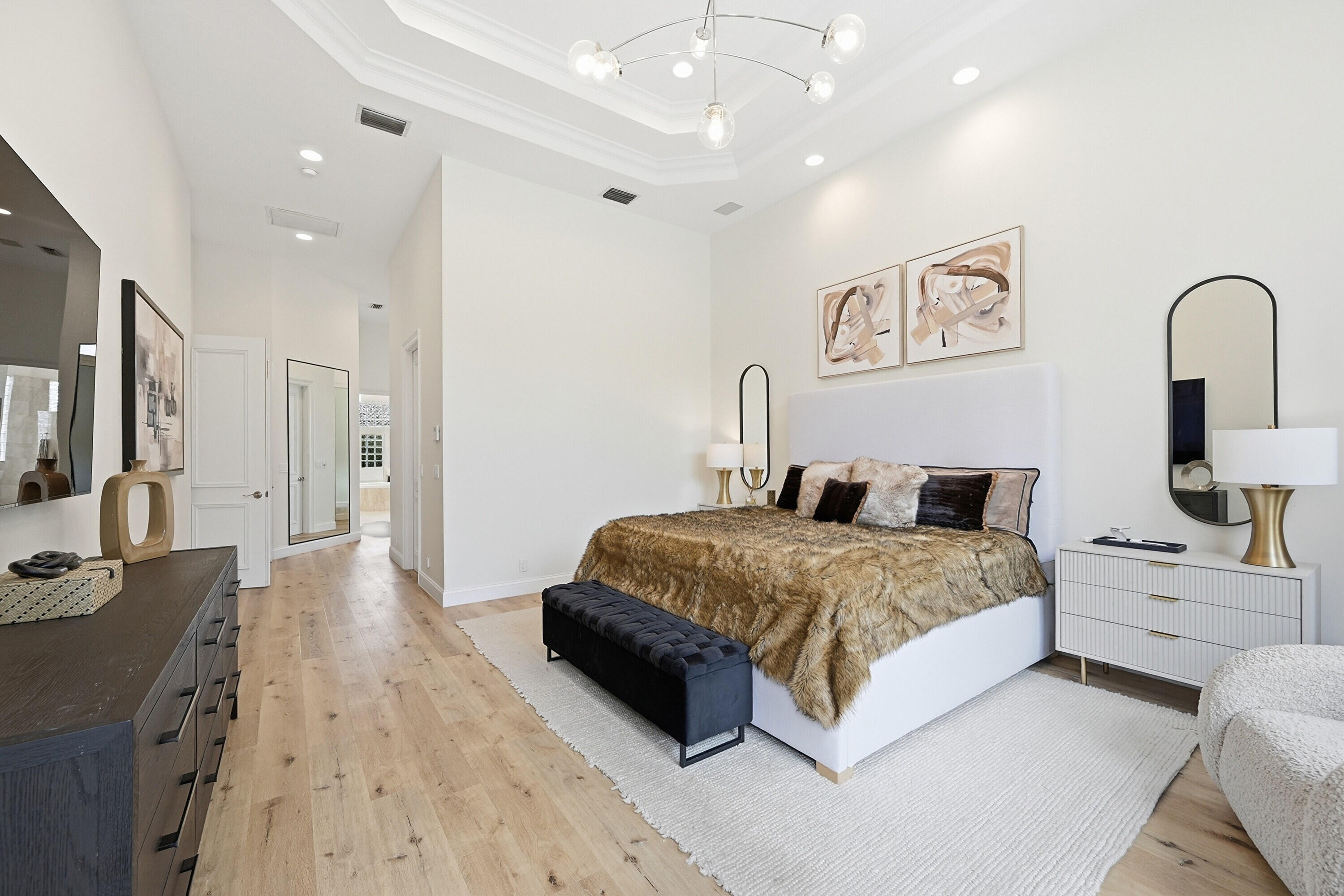 2399 Northwest 49th Lane Boca Raton, FL 33431 - Photo 30 of 75 a spacious bedroom with a bed and a large mirror