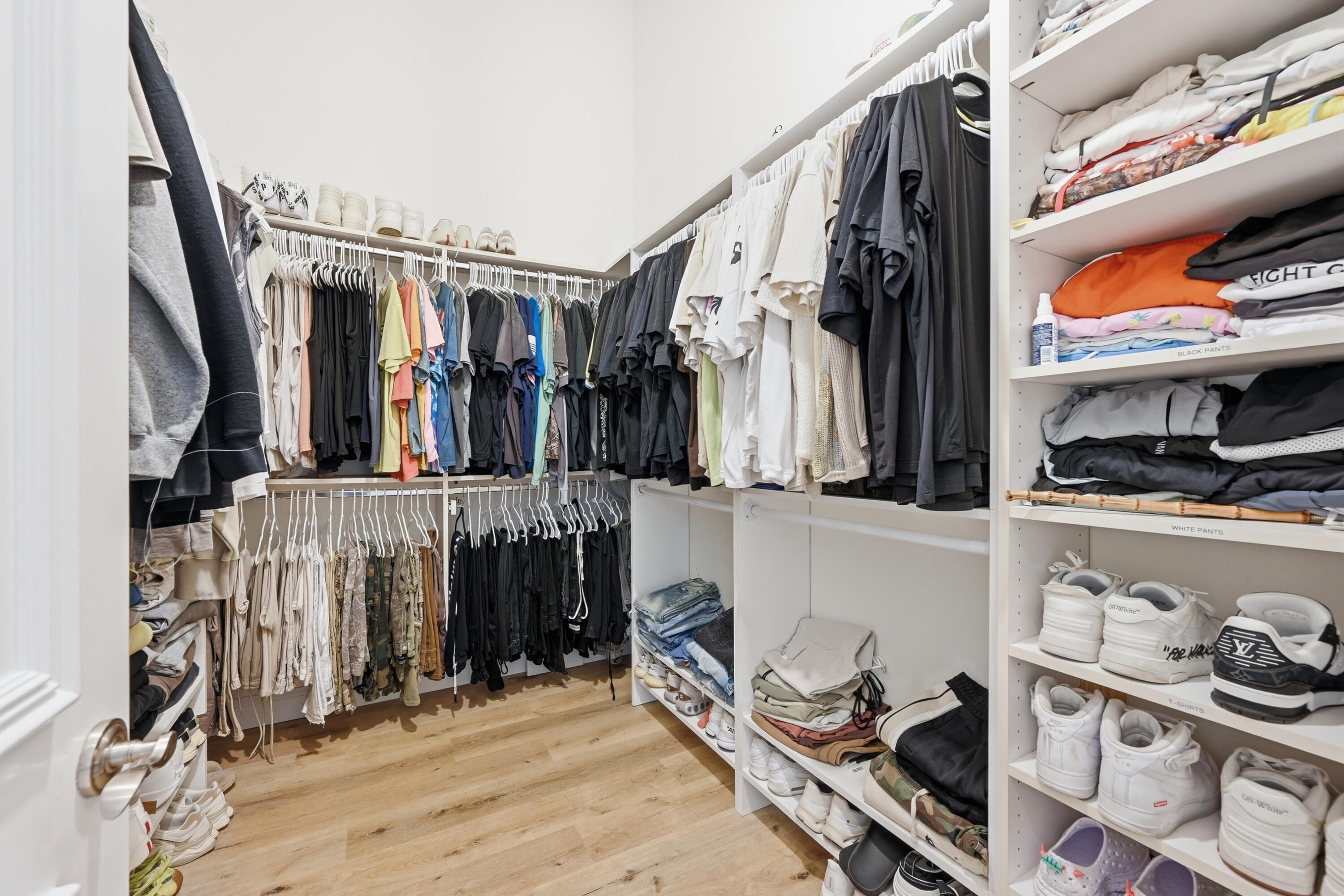 2399 Northwest 49th Lane Boca Raton, FL 33431 - Photo 38 of 75 a view of walk in closet with clothes and shoes