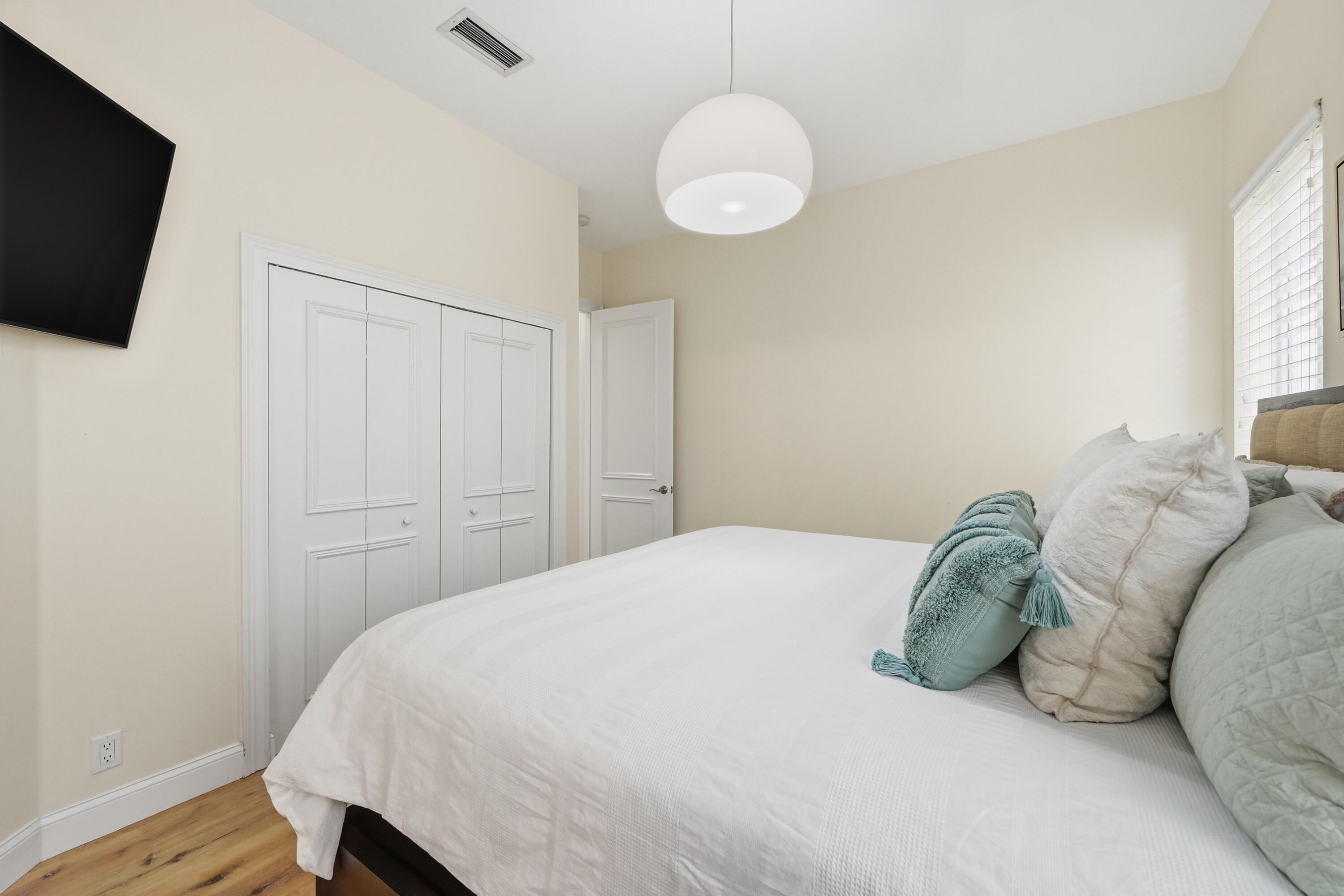 2399 Northwest 49th Lane Boca Raton, FL 33431 - Photo 43 of 75 a bedroom with a bed and a flat screen tv