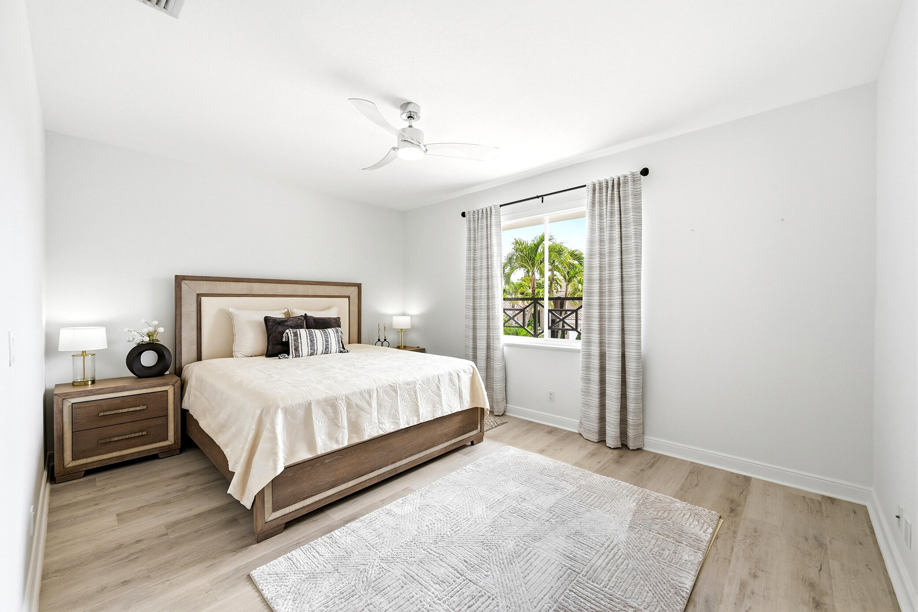 2399 Northwest 49th Lane Boca Raton, FL 33431 - Photo 53 of 75 a bedroom with a large bed and a window