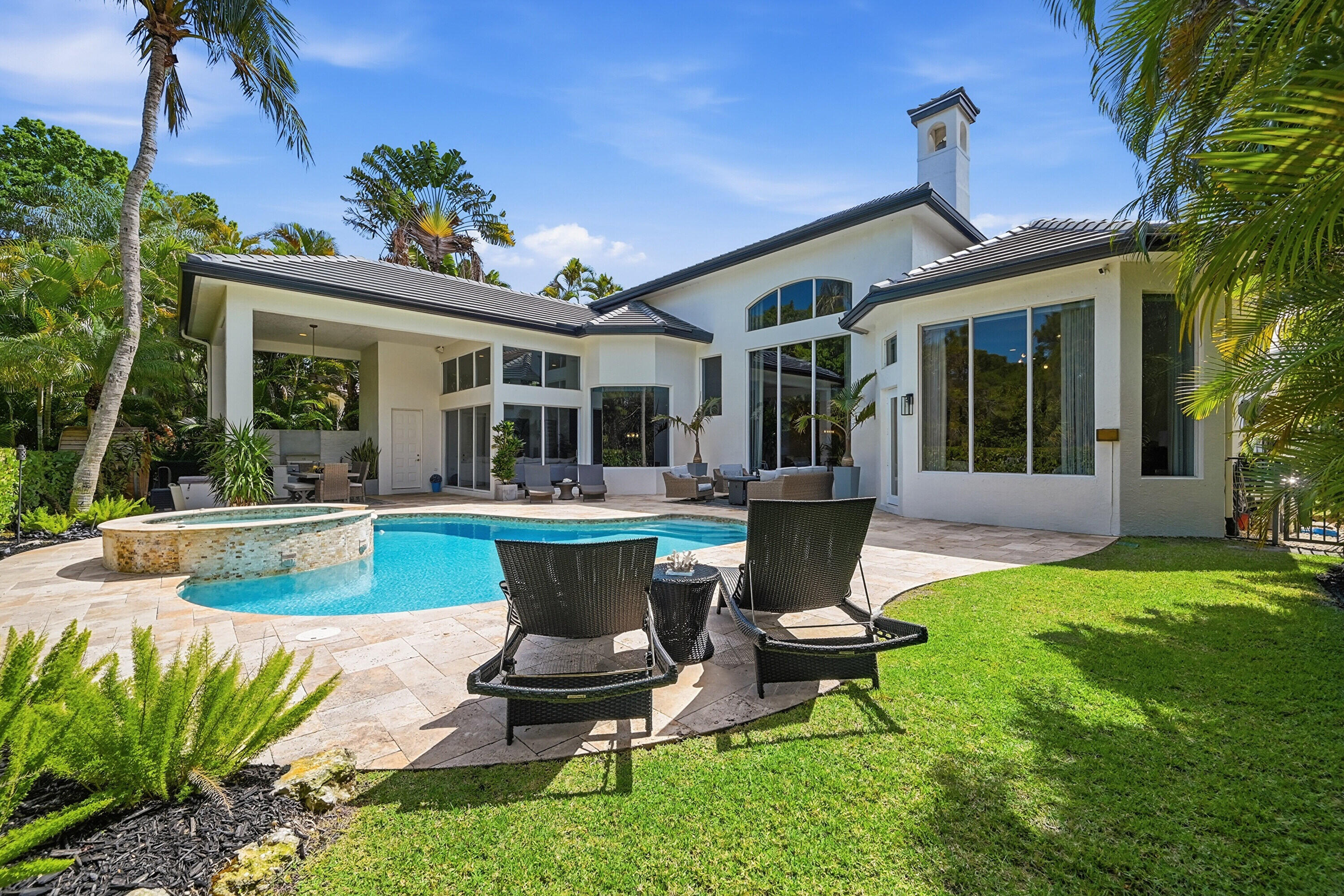 2399 Northwest 49th Lane Boca Raton, FL 33431 - Photo 63 of 75 a view of a house with backyard sitting area and swimming pool