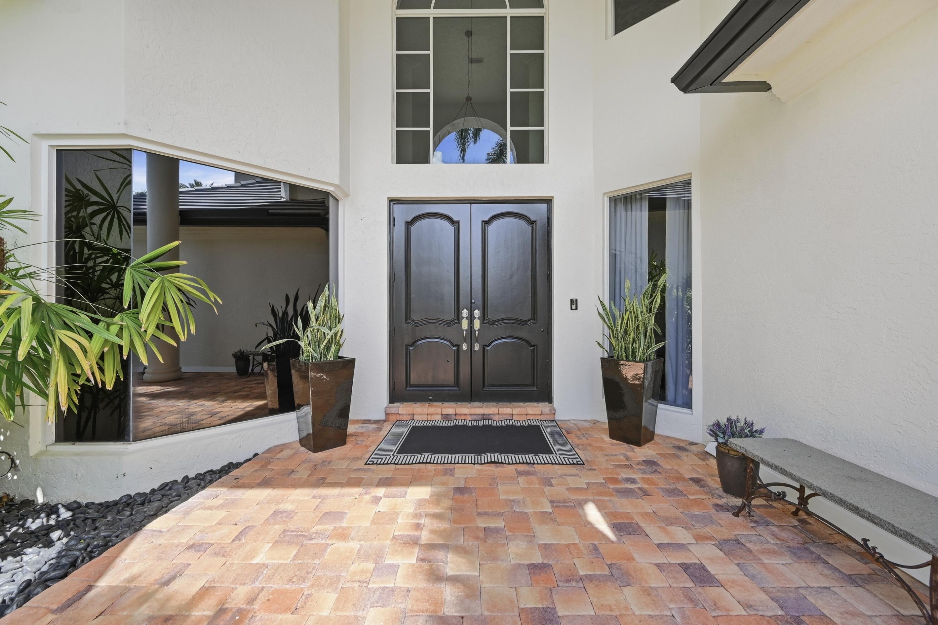 2399 Northwest 49th Lane Boca Raton, FL 33431 - Photo 7 of 75 a view of a entryway door front of house