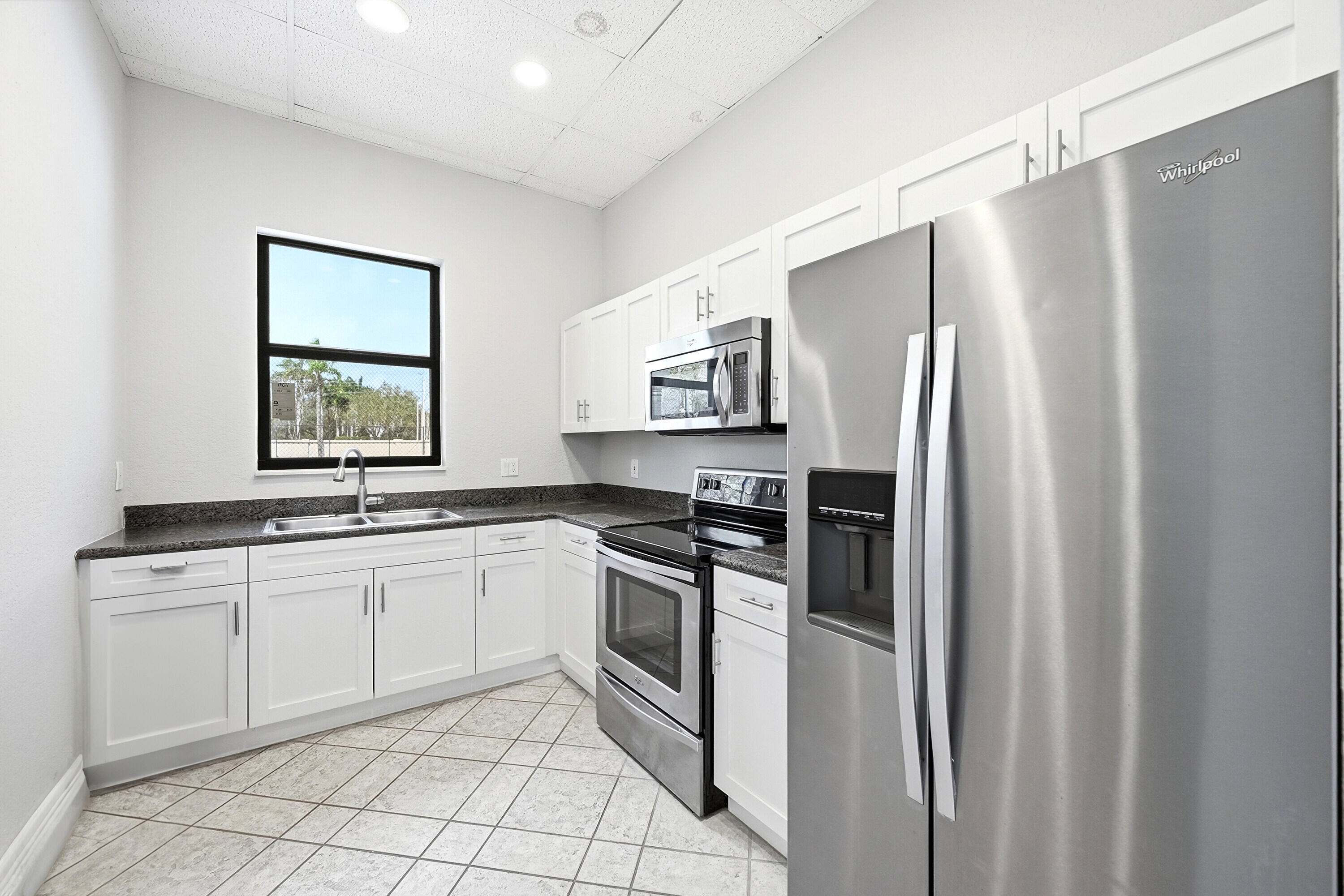 2399 Northwest 49th Lane Boca Raton, FL 33431 - Photo 72 of 75 a kitchen with stainless steel appliances a refrigerator sink and microwave