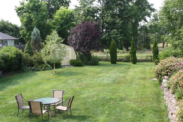 200 Still River Road Harvard, MA 01451 - Photo 20 of 28 a view of a chair and table on the green field