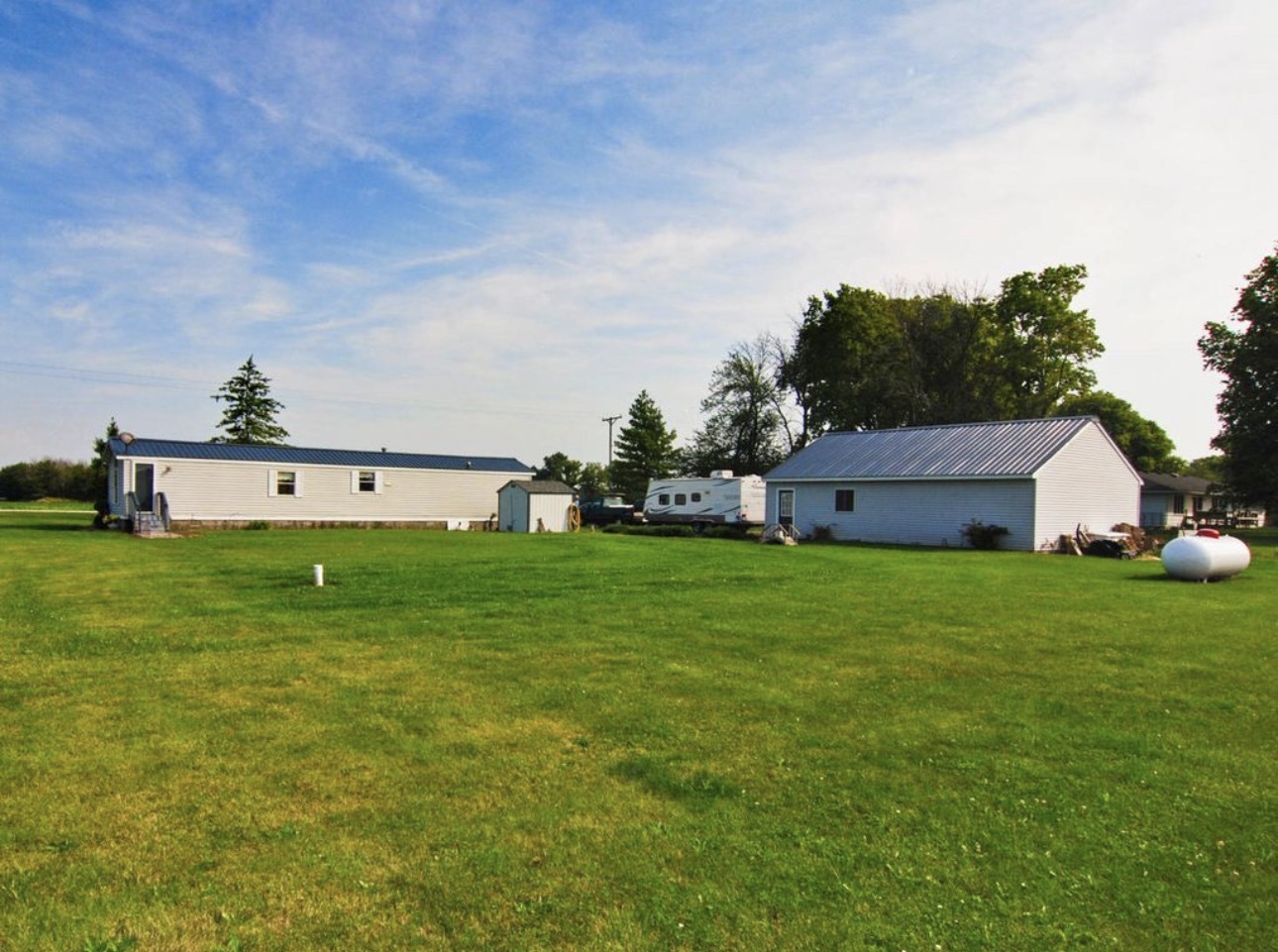 33850 East 2900 N Road Dwight, IL 60420 - Photo 13 of 16 a view of a big house with a big yard potted plants and large tree