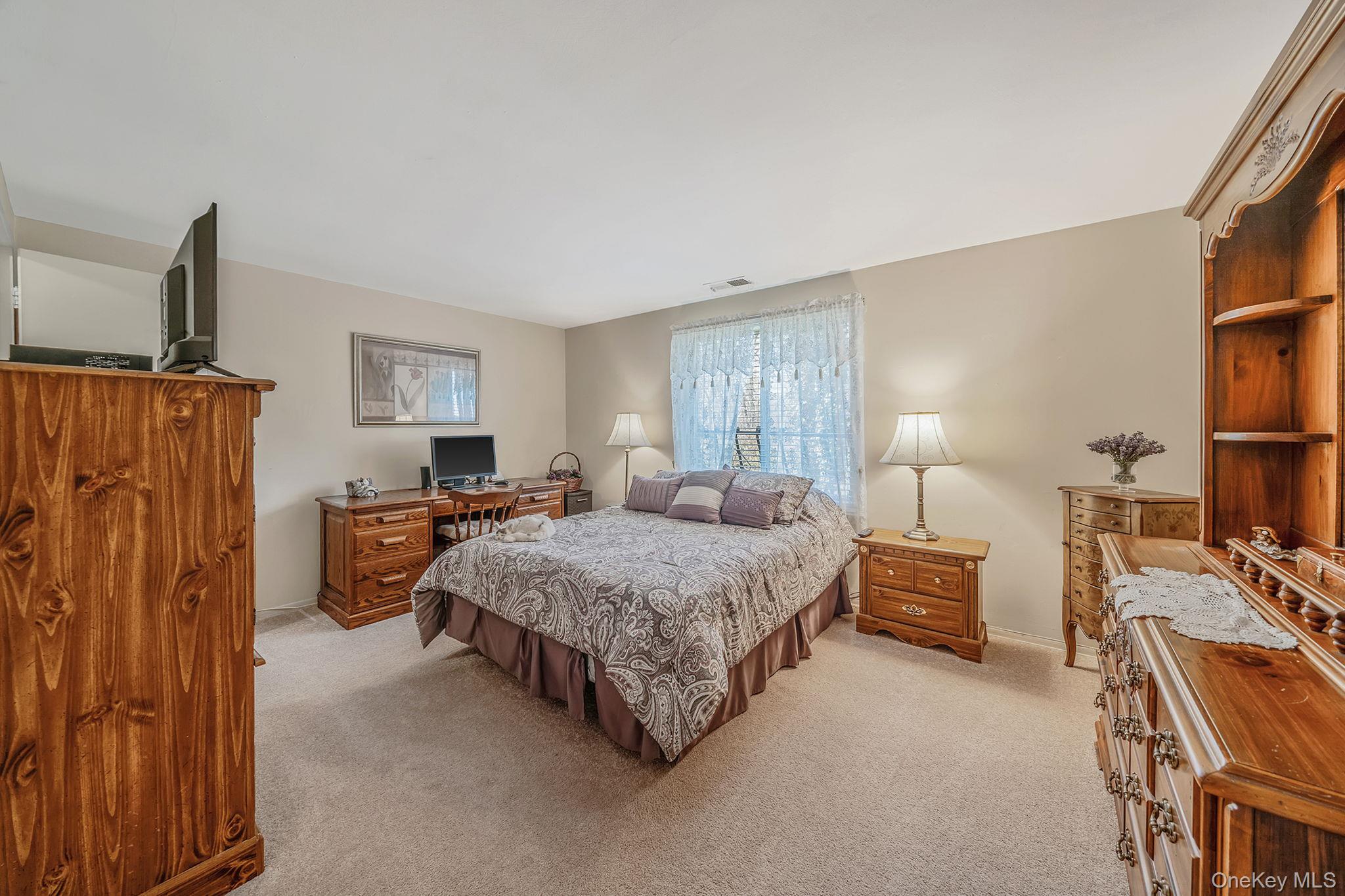 310 Birchwood Road Medford, NY 11763 - Photo 15 of 43 a bed room with a bed furniture and a window