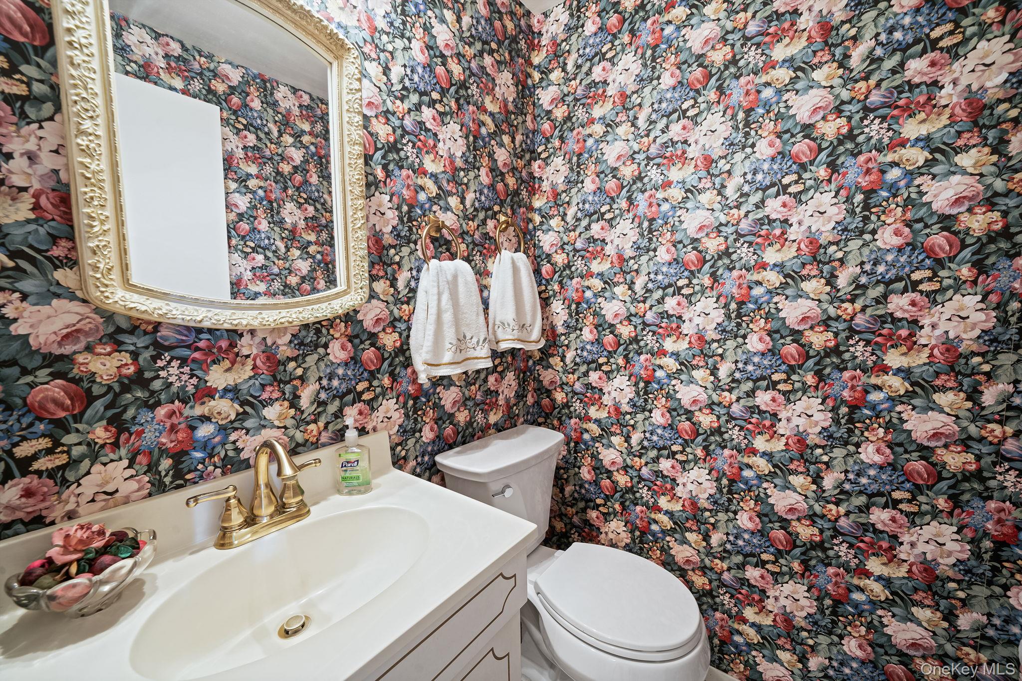 310 Birchwood Road Medford, NY 11763 - Photo 18 of 43 a bathroom with a toilet sink and mirror