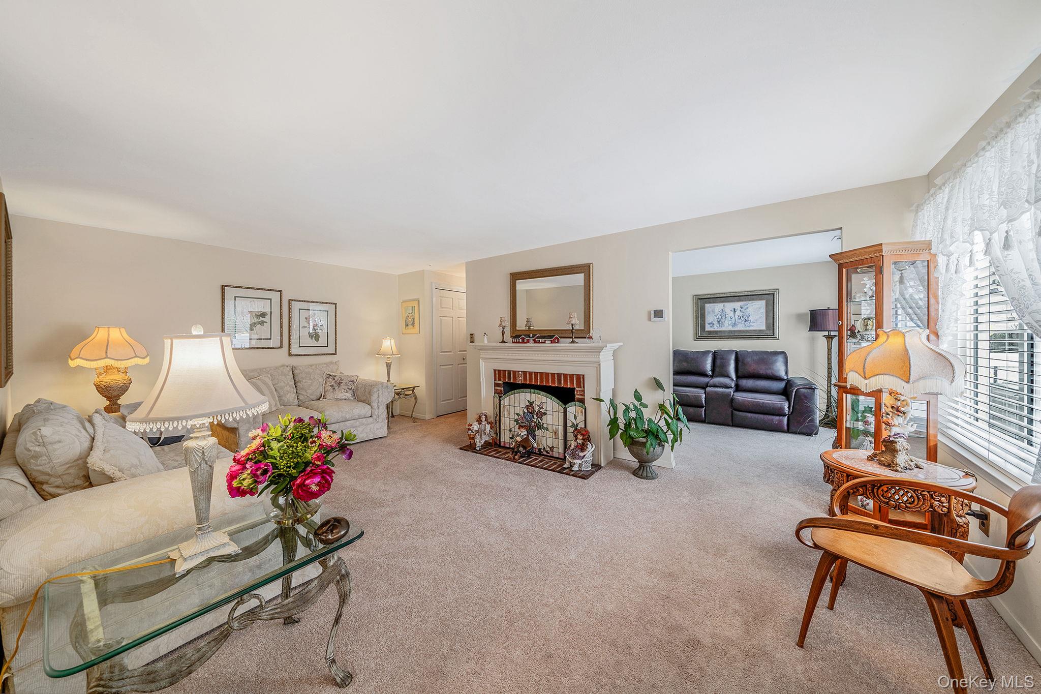 310 Birchwood Road Medford, NY 11763 - Photo 3 of 43 a living room with furniture and a fireplace
