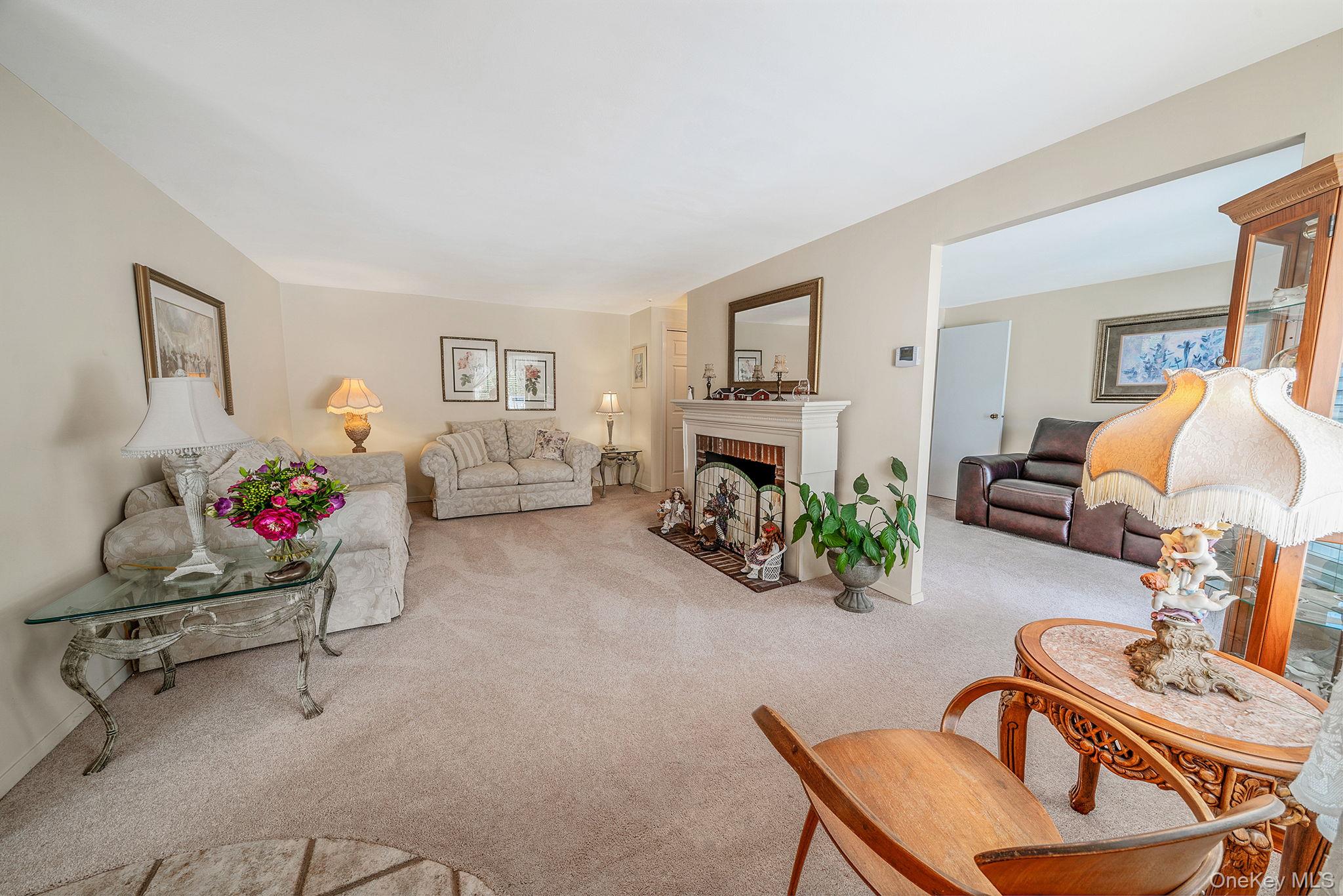 310 Birchwood Road Medford, NY 11763 - Photo 4 of 43 a living room with furniture and a fireplace