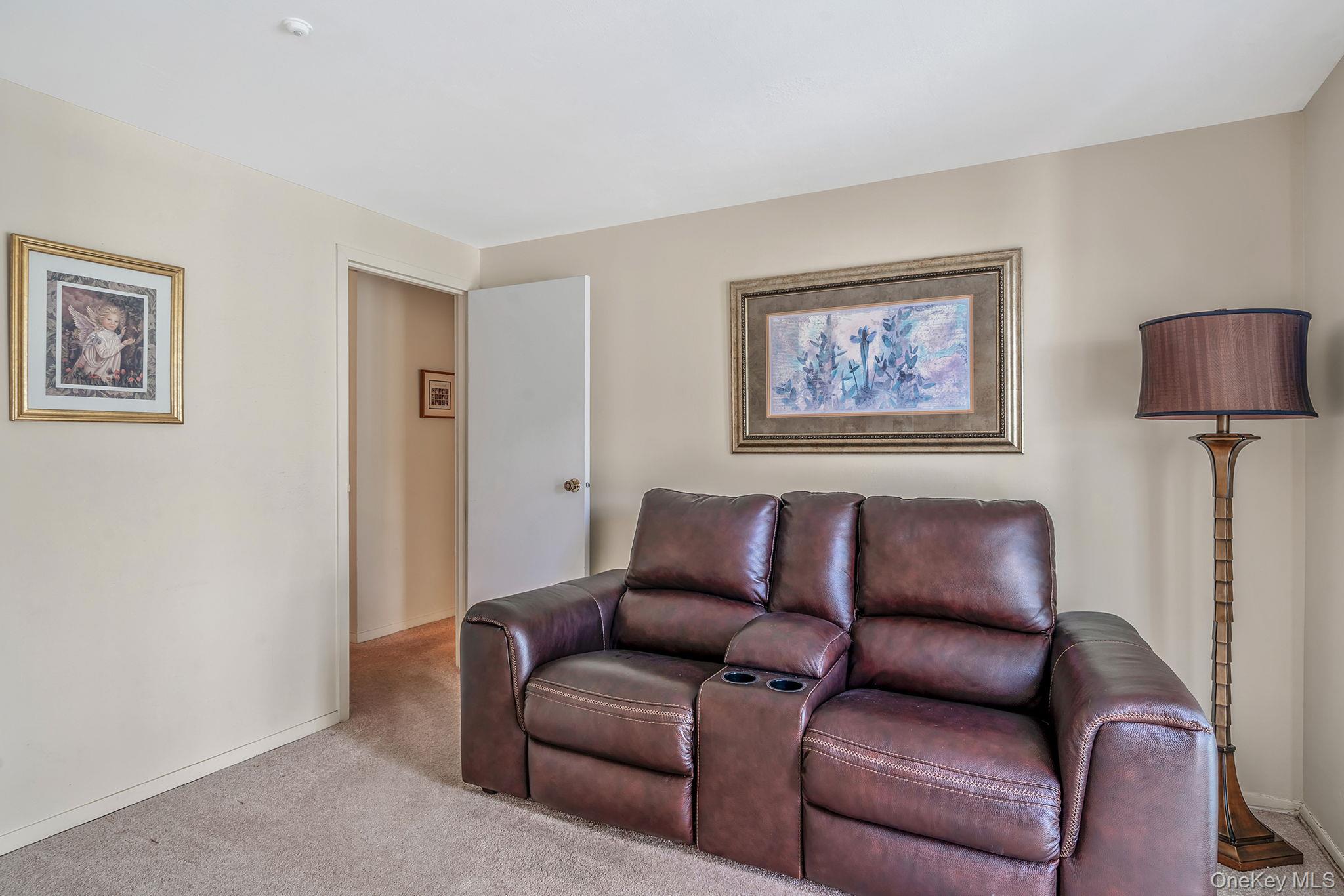 310 Birchwood Road Medford, NY 11763 - Photo 8 of 43 a blue couch sitting in a living room with a couch