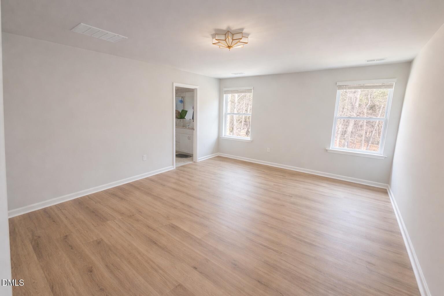 217 Beacon Hl Road Lillington, NC 27546 - Photo 12 of 24 an empty room with wooden floor and windows