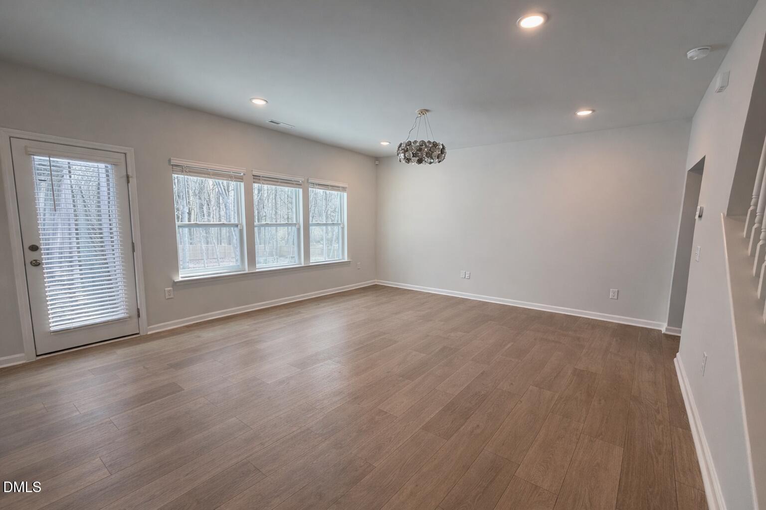 217 Beacon Hl Road Lillington, NC 27546 - Photo 7 of 24 an empty room with wooden floor and windows
