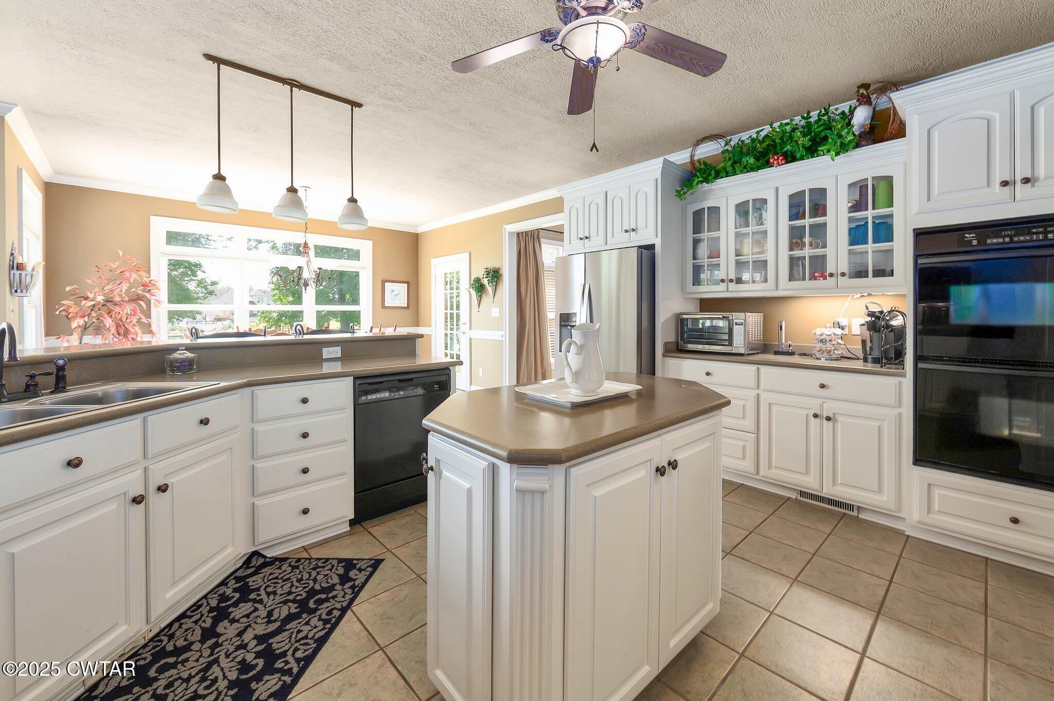 18 Admirals Pointe Jackson, TN 38305 - Photo 18 of 86 a kitchen with stainless steel appliances kitchen island granite countertop a sink and cabinets