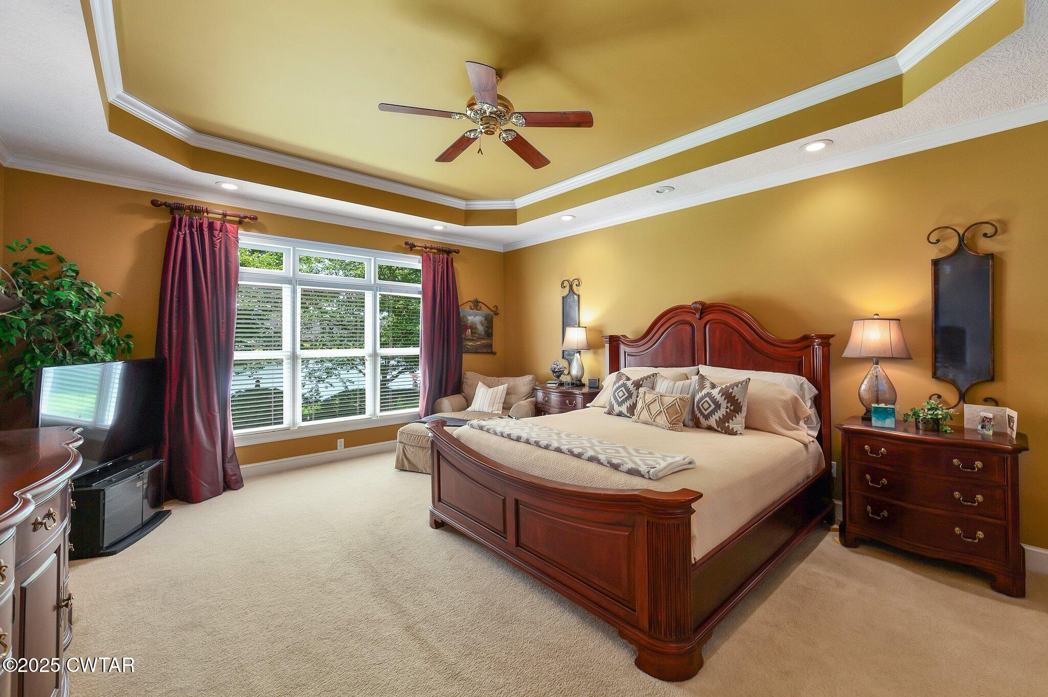 18 Admirals Pointe Jackson, TN 38305 - Photo 30 of 86 a bedroom with a bed lamp and a flat tv screen