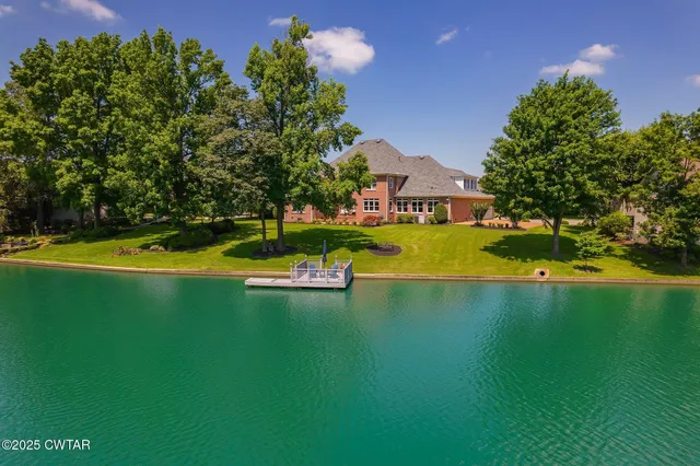 an aerial view of a houses with a lake view