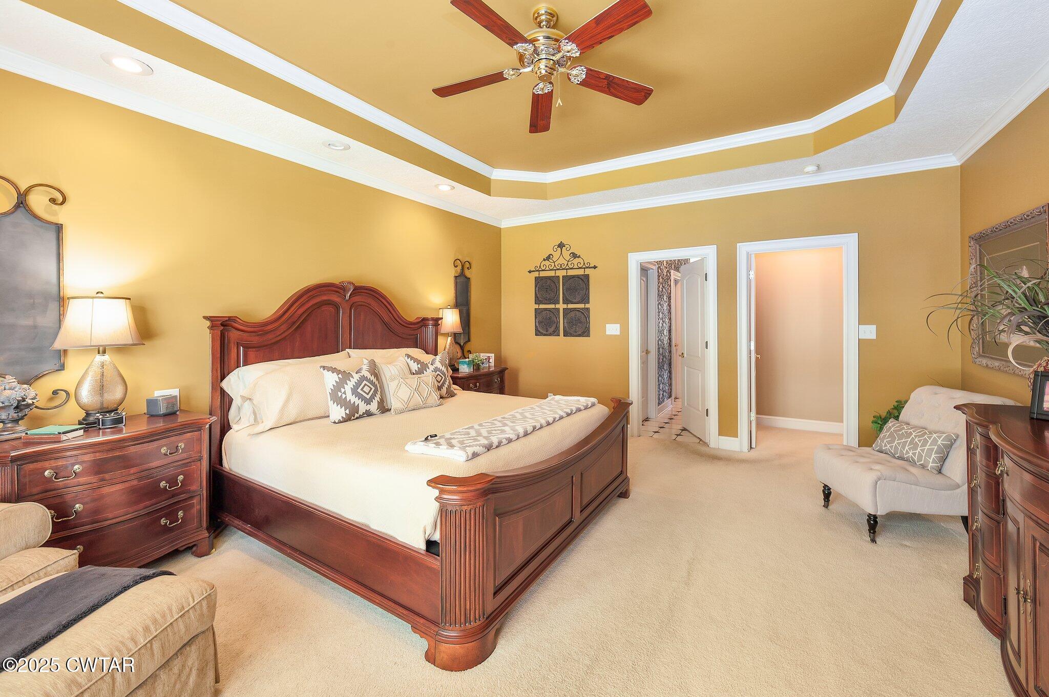 18 Admirals Pointe Jackson, TN 38305 - Photo 31 of 86 a spacious bedroom with a bed and a chandelier