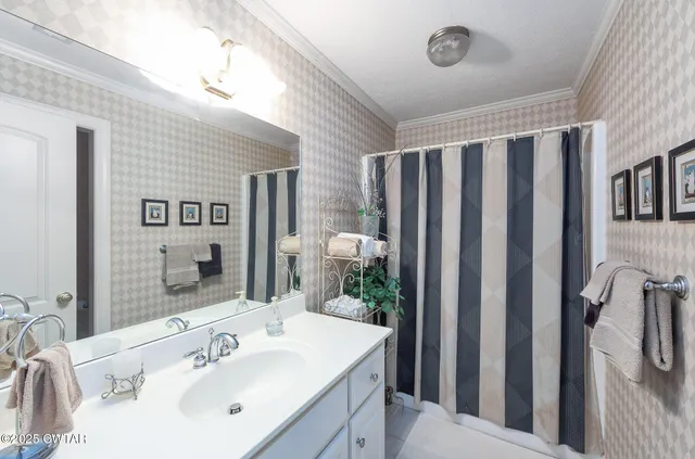 an aerial view of residential houses with outdoor space and lake view