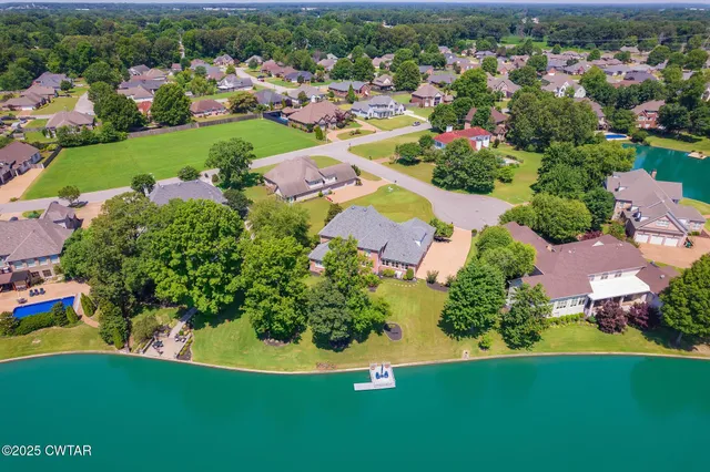a front view of a house with swimming pool having outdoor seating