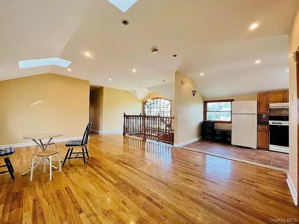 a view of a kitchen with furniture and wooden floor
