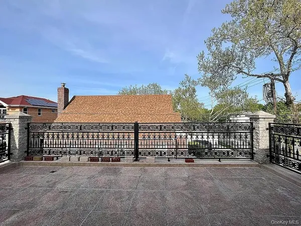 a view of a white house with a street from a balcony