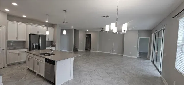 a view of a kitchen with a sink and a refrigerator