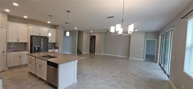 a kitchen with stainless steel appliances a refrigerator sink and microwave
