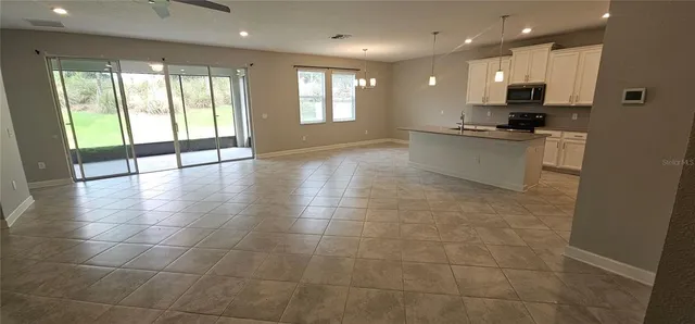 a view of kitchen with refrigerator and window
