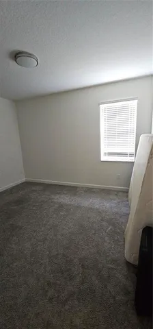 a view of a hallway with a white walls and stairs