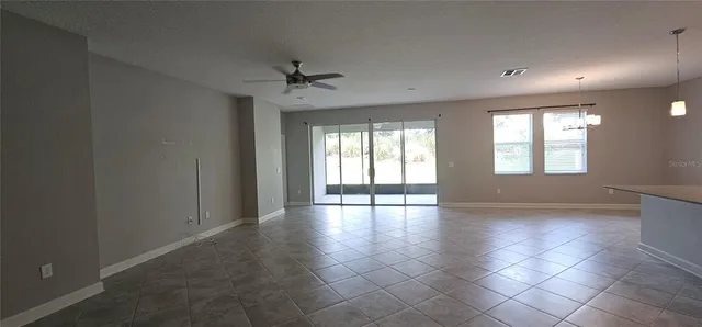 a view of an empty room and floor to ceiling window