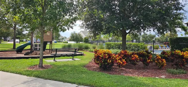a view of a tennis ground and trees in the background