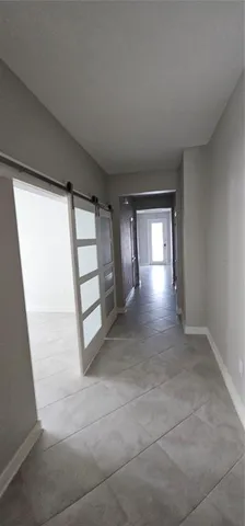 a kitchen that has a lot of cabinets and stainless steel appliances