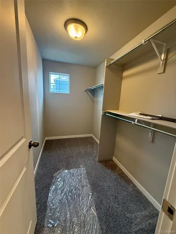 a view of a room with rack and a window