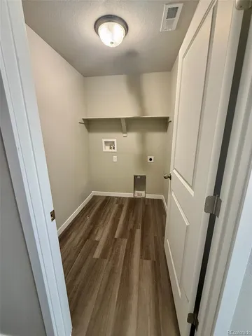 an entryway view with wooden floor and staircase