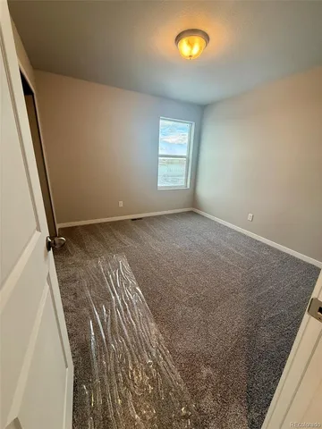 a view of a room with a bed