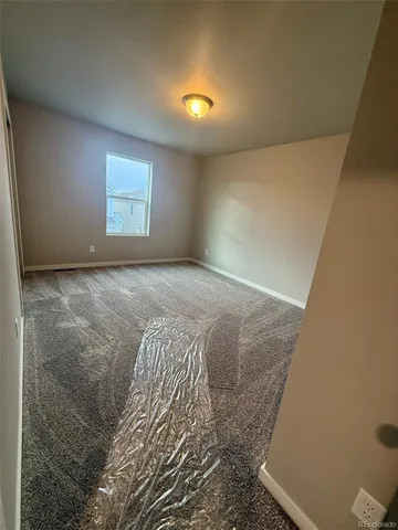 a bathroom with a granite countertop sink and a toilet