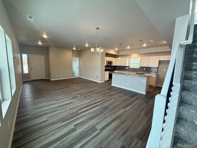 a view of a kitchen with cabinets stainless steel appliances