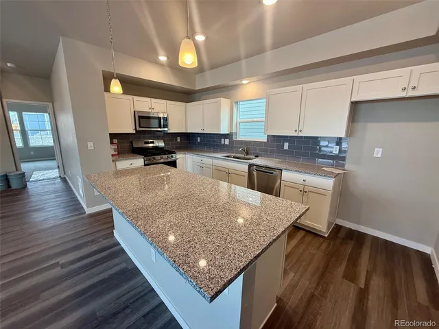 a kitchen with a sink microwave and cabinets