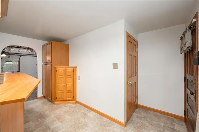 a view of a room with wooden floor and a ceiling fan