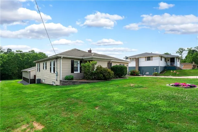 a view of a house with a backyard