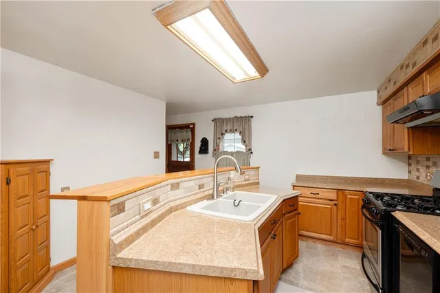 a kitchen that has a sink and a stove