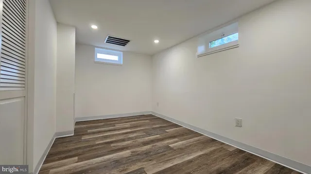 a view of a room with wooden floor and ceiling fan