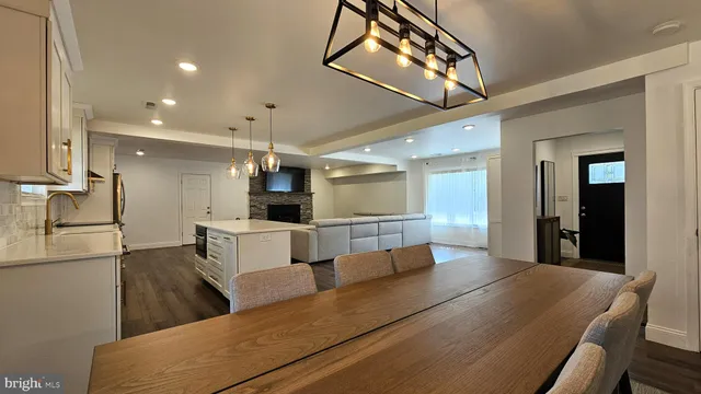 a living room with furniture and kitchen view