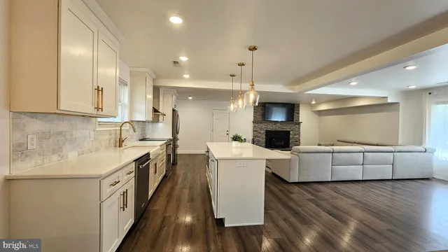 a large kitchen with cabinets wooden floor and stainless steel appliances