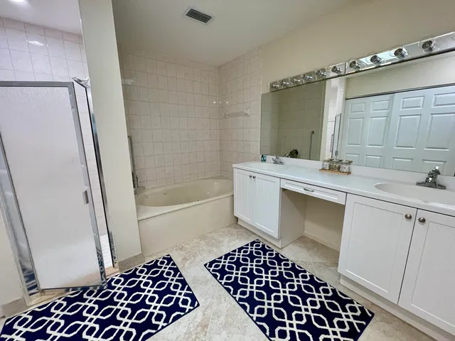 a bathroom with a sink a toilet a mirror and shower