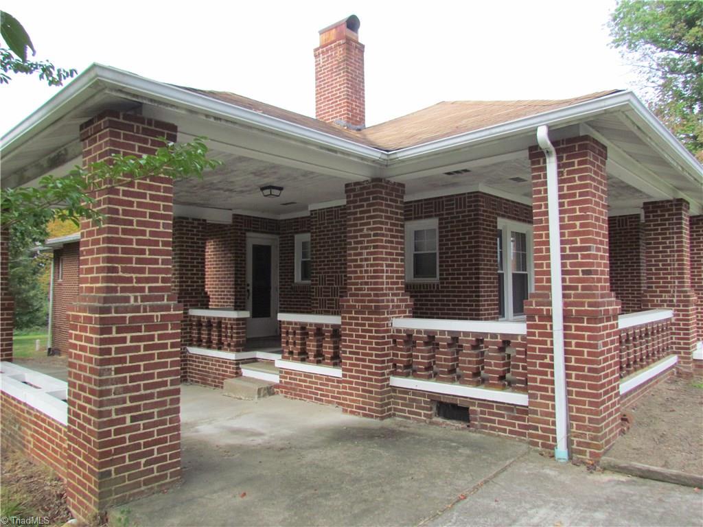 Lovely brick home with wrap-around porch, built in window boxes, and charming brick work.