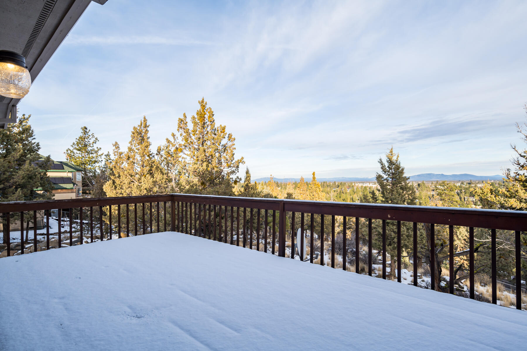 3808 Northwest Summerfield Road Bend, OR 97703 - Photo 8 of 38 Step outside from the kitchen onto the main level deck for more spanning views.