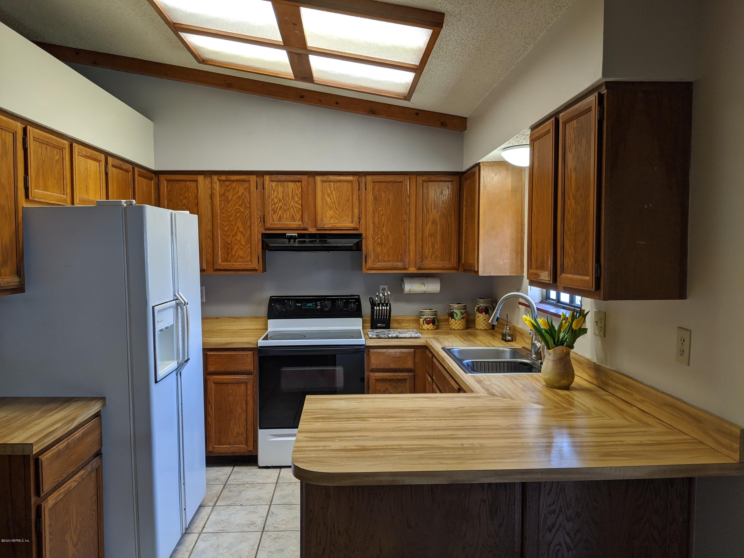 106 Jasmine Road St. Augustine, FL 32086 - Photo 4 of 11 a kitchen with kitchen island a sink appliances and cabinets