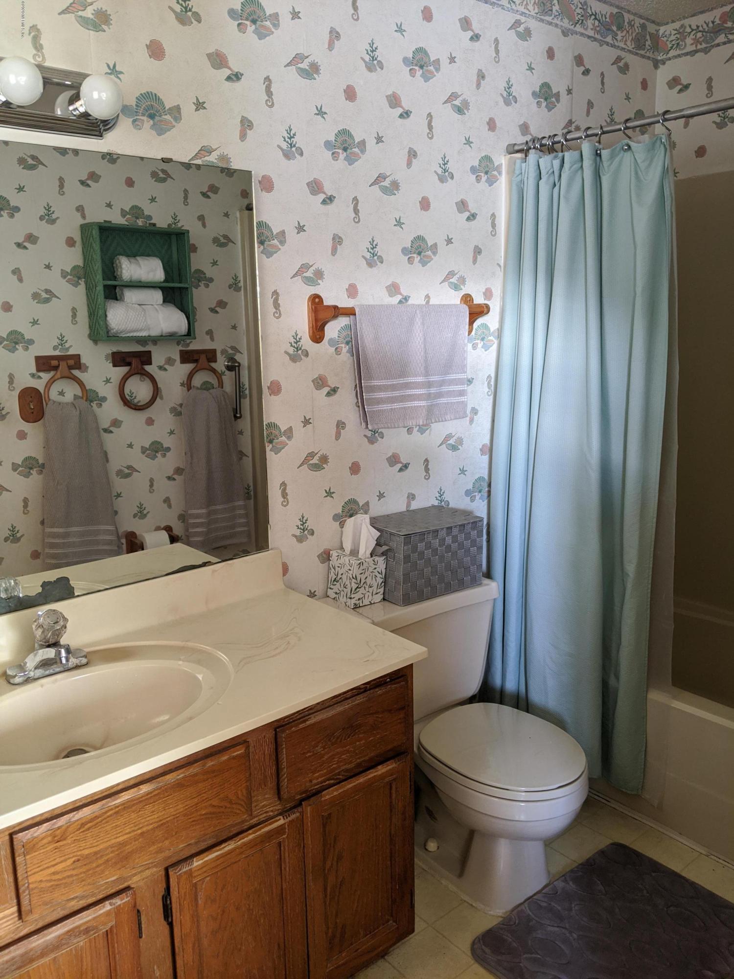 106 Jasmine Road St. Augustine, FL 32086 - Photo 7 of 11 a bathroom with a sink a toilet and shower