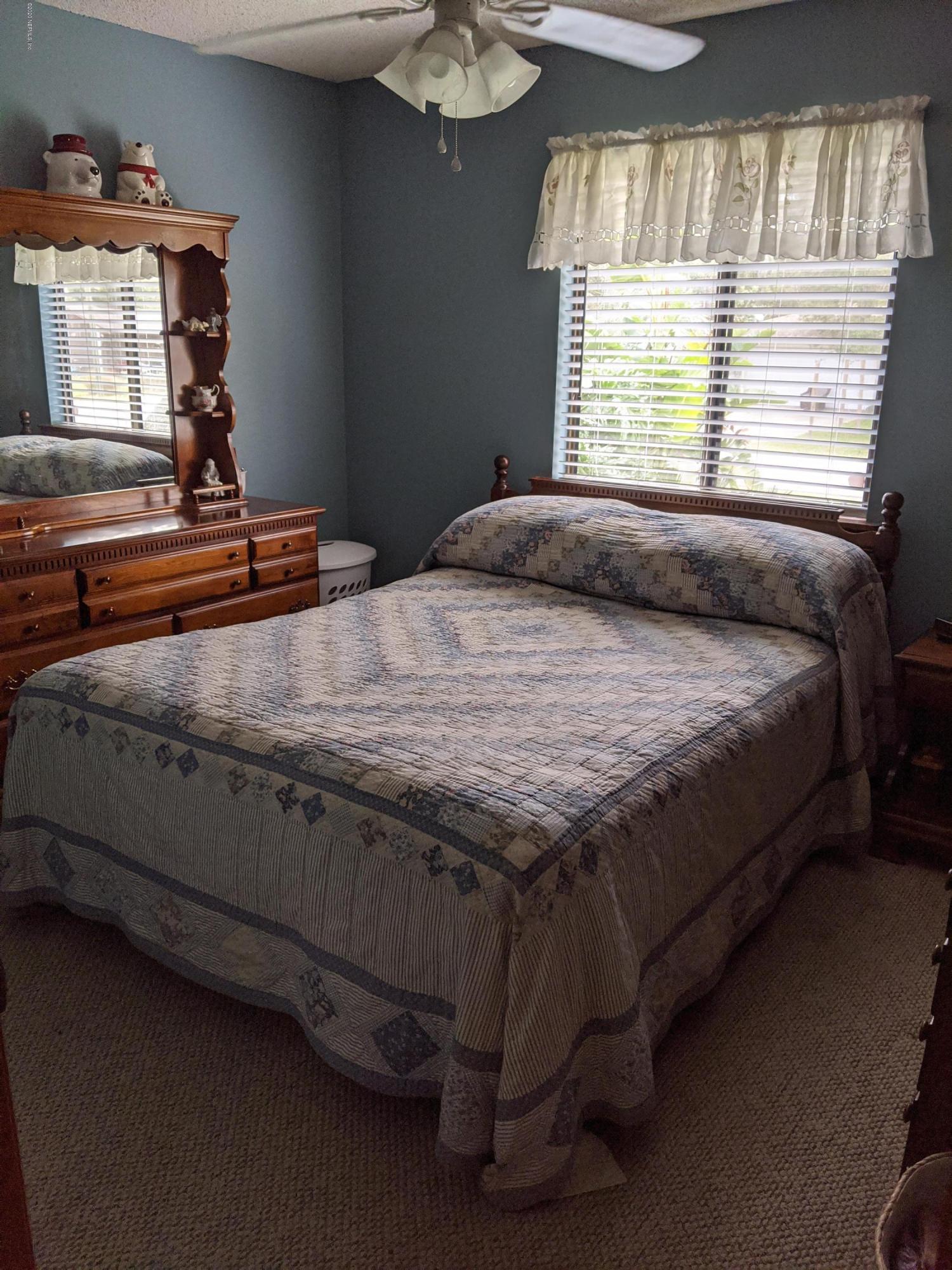 106 Jasmine Road St. Augustine, FL 32086 - Photo 8 of 11 a bedroom with a bed and a window